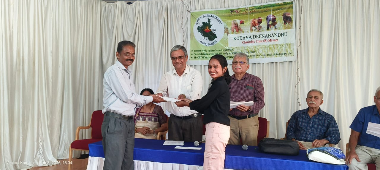 Prof Benedict R Saldanha, Principal, Cauvery College, Virajapet, handing over the scholarship cheque to one of the beneficiaries on 06/02/2026 at the college auditorium.